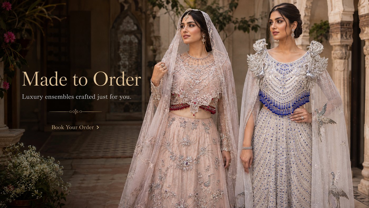 Two models in hand-embellished Pakistani bridal lehengas made to order by Veera Studio