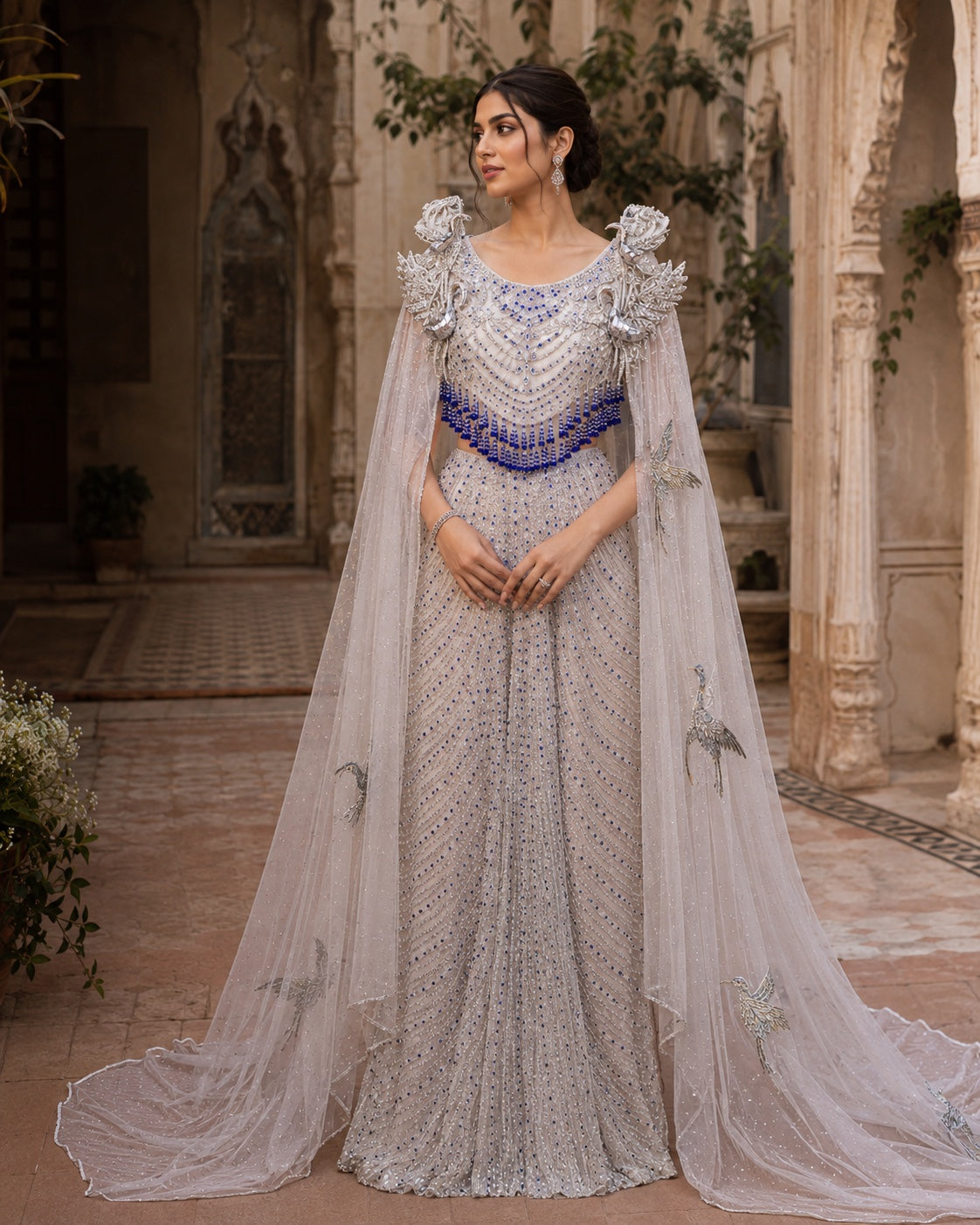 Silver and sapphire occasion gown with detailed bodice and cape